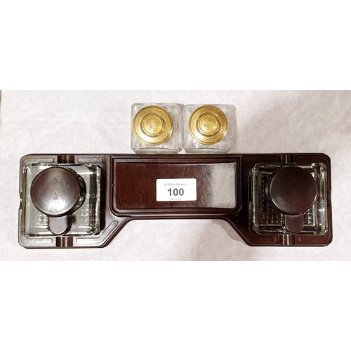 100 - A vintage Bakelite ink stand and two brass topped ink wells, length 11.75