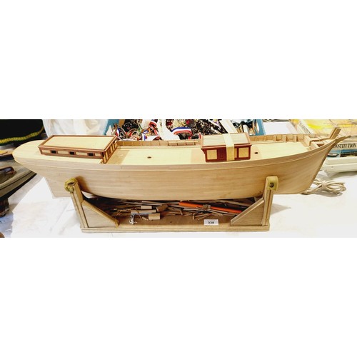 338 - A part built wooden model boat, length 34