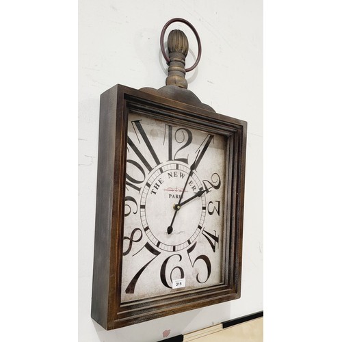 315 - A vintage style wall clock in working order, length 27