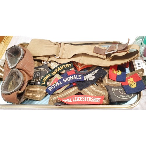 141 - Military badges, goggles and a belt. UK shipping £14.