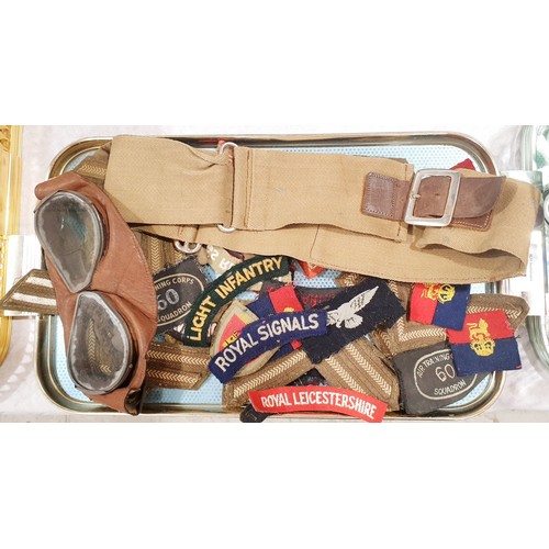 141 - Military badges, goggles and a belt. UK shipping £14.