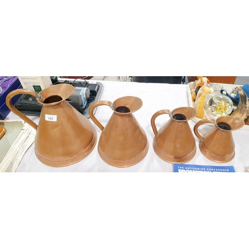 159 - A set of four antique graduating copper jugs, the tallest 10.5
