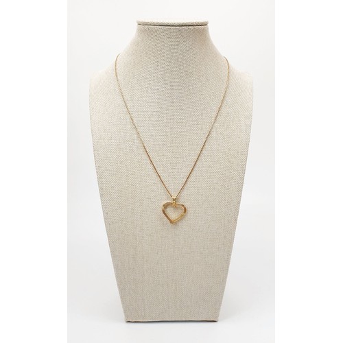 13 - A 9ct gold heart shaped pendant on a 9ct gold chain, weight 3g. UK shipping £14.