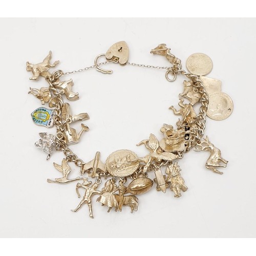 5 - A silver hallmarked charm bracelet, weight 65g. UK shipping £14.