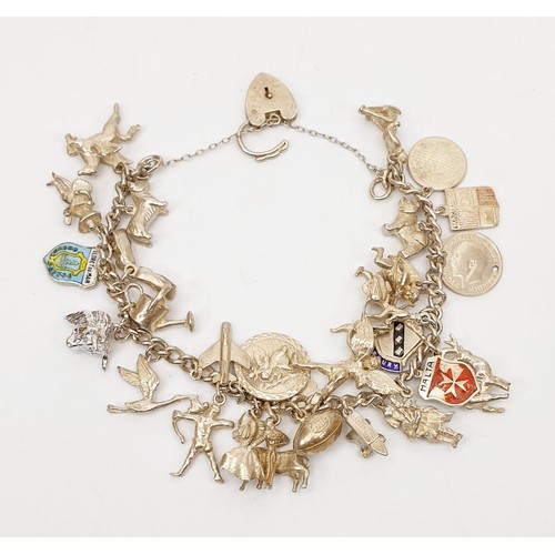 5 - A silver hallmarked charm bracelet, weight 65g. UK shipping £14.