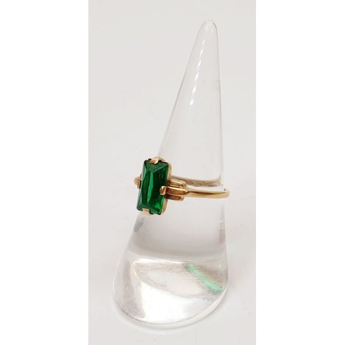 8 - A 9ct gold ring set with a green stone, size N, gross weight 2.3g. UK shipping £14.