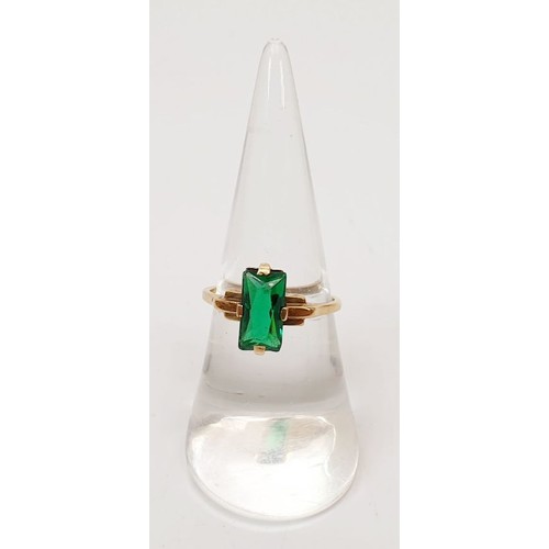 8 - A 9ct gold ring set with a green stone, size N, gross weight 2.3g. UK shipping £14.