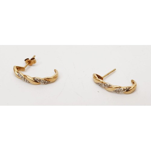 19 - A pair of 9ct gold earrings set with diamonds, gross weight 1.4g. UK shipping £14.