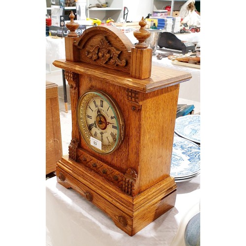 53 - An antique oak mantel and alarm clock, the movement and dial signed Fattorrini & Sons, Bradford, hei... 