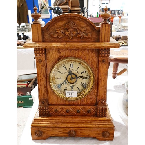 53 - An antique oak mantel and alarm clock, the movement and dial signed Fattorrini & Sons, Bradford, hei... 