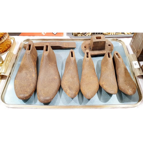 94 - Three pairs of cast iron shoe lasts and stand. No shipping. Arrange collection or your own packer an... 