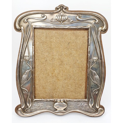 221 - A hallmarked silver Art Nouveau embossed photo frame, having a silver wedding inscription, length 12... 