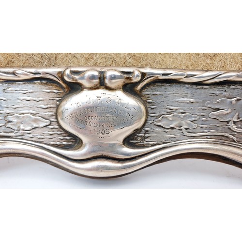 221 - A hallmarked silver Art Nouveau embossed photo frame, having a silver wedding inscription, length 12... 