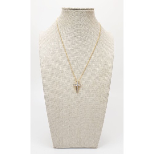 8 - An 18ct diamond set cross on a 9ct gold chain, chain length 16