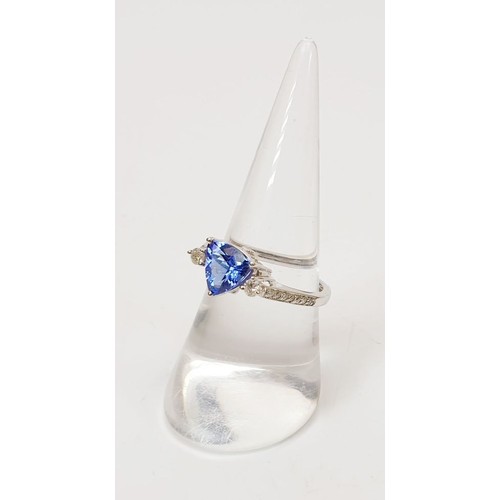 15 - A hallmarked 18ct white gold tanzanite and diamond ring, weight 3.1g, size O/P. UK shipping £14.