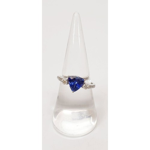 15 - A hallmarked 18ct white gold tanzanite and diamond ring, weight 3.1g, size O/P. UK shipping £14.