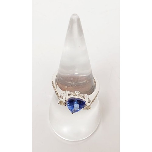 15 - A hallmarked 18ct white gold tanzanite and diamond ring, weight 3.1g, size O/P. UK shipping £14.