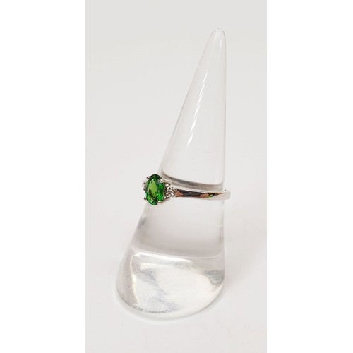 16 - A hallmarked 18ct white gold tsavorite and diamond ring, gross weight 2g, size N/O. UK shipping £14.