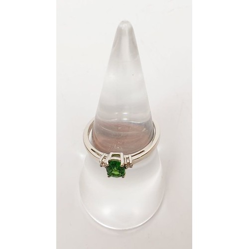 16 - A hallmarked 18ct white gold tsavorite and diamond ring, gross weight 2g, size N/O. UK shipping £14.