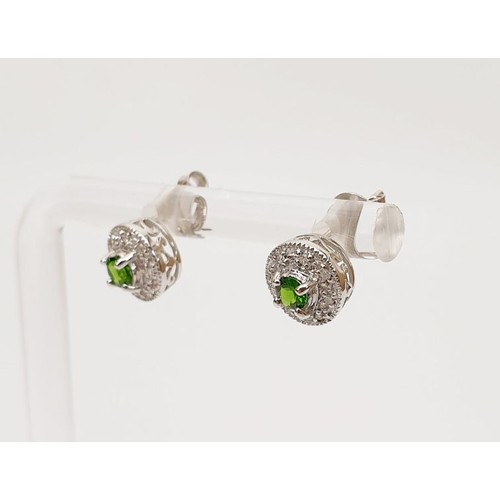 24 - A pair of hallmarked 18ct white gold earrings set with tsavorite and diamond, gross weight 1.8g. UK ... 