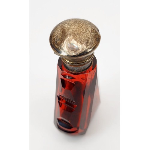 69 - An antique cranberry cut glass smelling salts bottle with stopper and silver plated lid, A/F, height... 