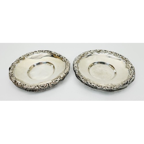 27 - William Comyns: A pair of hallmarked silver dishes with pierce work rims, A/F, diameter 4.25