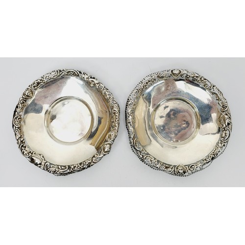 27 - William Comyns: A pair of hallmarked silver dishes with pierce work rims, A/F, diameter 4.25