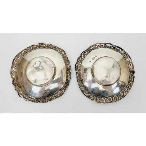 27 - William Comyns: A pair of hallmarked silver dishes with pierce work rims, A/F, diameter 4.25