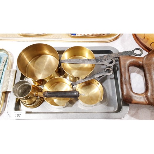 107 - A set of four graduated brass pans with cast handles and brass Turkish coffee pot. UK shipping £14.