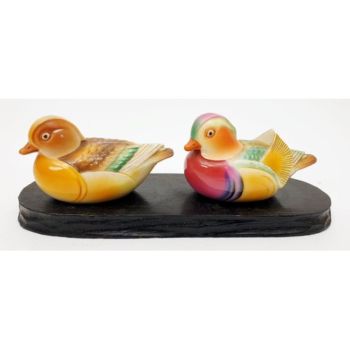 284 - Two hand painted Chinese ceramic ducks on a wooden stand, each signed, length 5.5