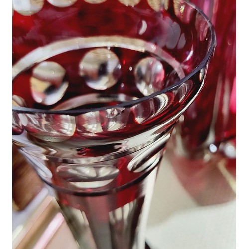 180 - Two red cut glass vases and one other which is A/F, cranberry coloured vase, height 11.5