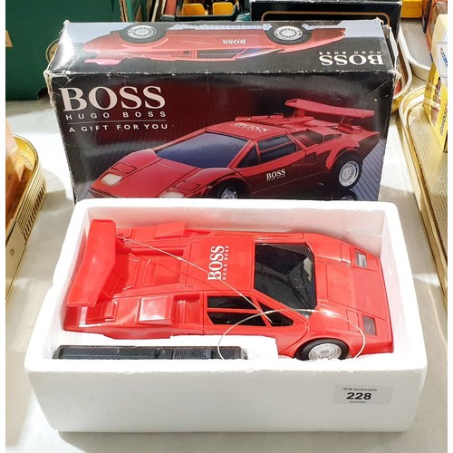 228 - A vintage boxed Hugo Boss remote control car together with a boxed model of an Aston Martin DB7. UK ... 