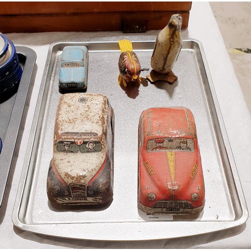 242 - Two vintage friction tin plate vehicles, one other tin plate vehicle and two clockwork animals. UK s... 