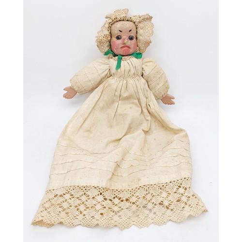 504 - Three antique wooden Punch and Judy puppets with plaster faces, with later fabric, the longest 22