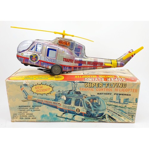 506 - A vintage boxed T.P.S. tin plate battery operated traffic control helicopter, length 15.5