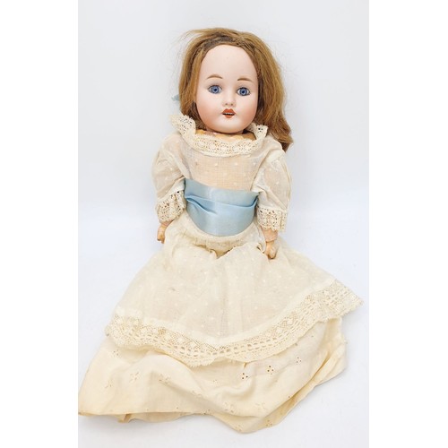 523 - A vintage doll with porcelain head and hands, composite body, A/F, length 15