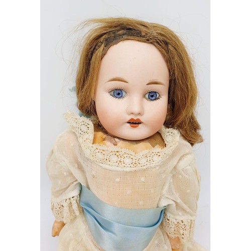 523 - A vintage doll with porcelain head and hands, composite body, A/F, length 15