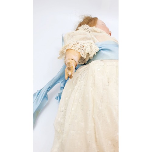 523 - A vintage doll with porcelain head and hands, composite body, A/F, length 15