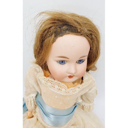 523 - A vintage doll with porcelain head and hands, composite body, A/F, length 15