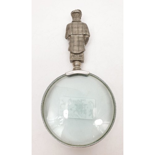 62 - A magnifying glass with a pewter handle in the form of Sherlock Holmes and 221B door, length 6.5