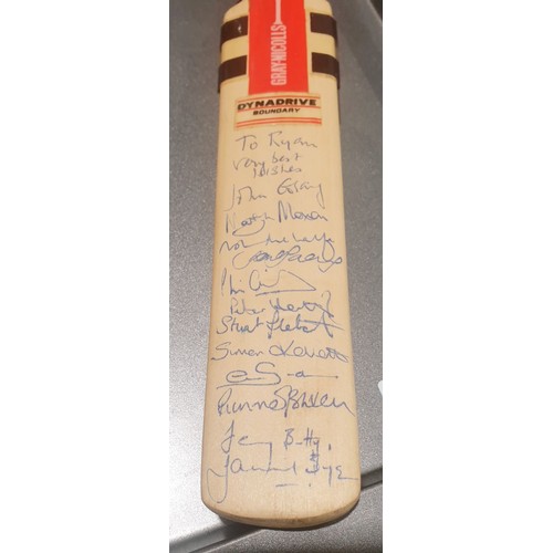 102 - A miniature cricket bat signed by England players including Martyn Moxon, length 12