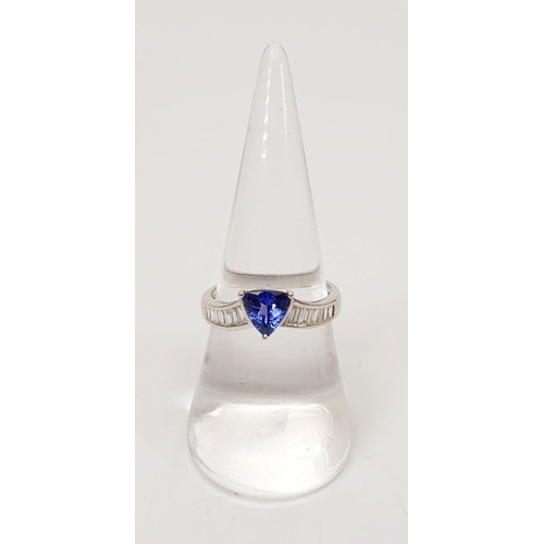 10 - An 18ct white gold tanzanite and diamond ring, size O, gross weight 2.9g. UK shipping £14.