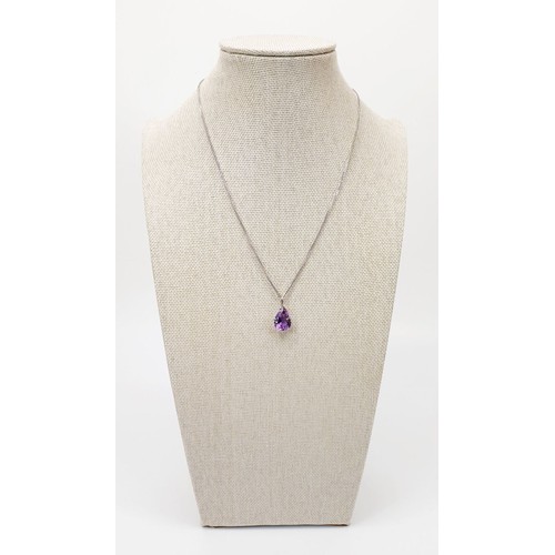 14 - An 18ct white gold amethyst set pendant on an 18ct white gold chain, chain length 15