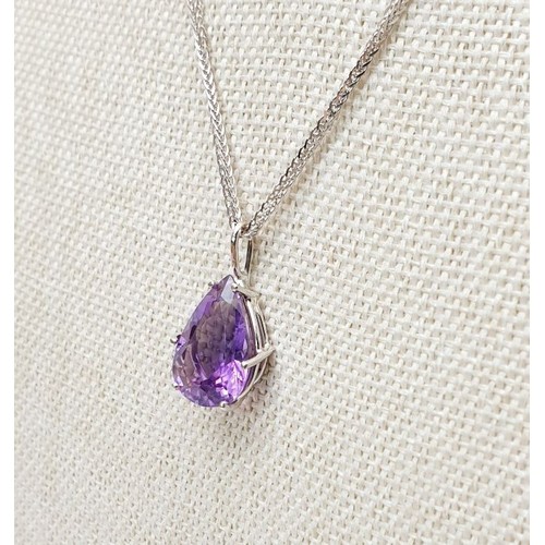 14 - An 18ct white gold amethyst set pendant on an 18ct white gold chain, chain length 15