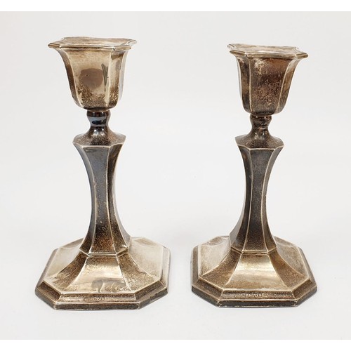 41 - A pair of weighted hallmarked silver candlesticks, height 5.75