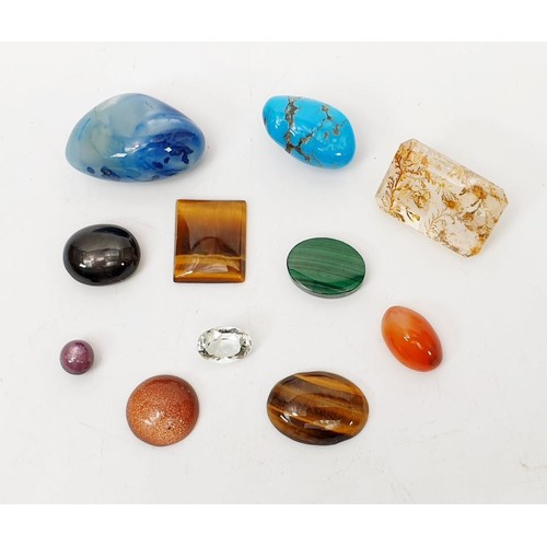 65 - A selection of semi-precious stones including malachite and tiger's eye and a stone which has been c... 