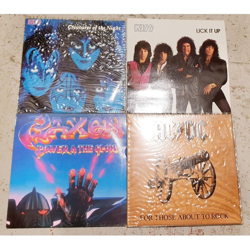 102 - Two Kiss LPs, a Saxon LP and an AC/DC LP. UK shipping £14.