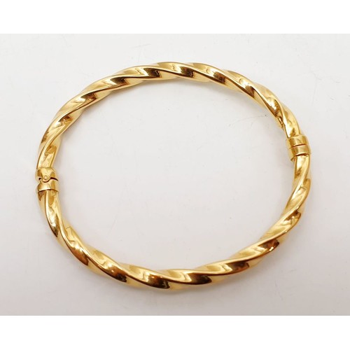 119 - A 9ct gold bangle, weight 6.5g. UK shipping £14.