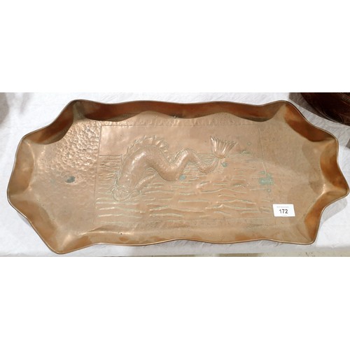 172 - An antique copper salmon dish with a relief sea monster and part hammer beaten finish, width 23