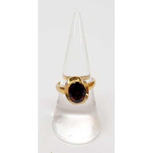 8 - A hallmarked 9ct gold ring set with a garnet and diamond, size N/O, gross weight 3.6g. UK shipping £... 